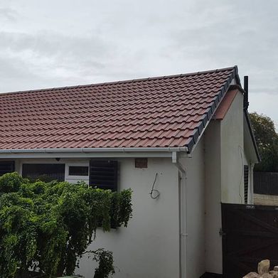 Side view of completed roofing work by our team