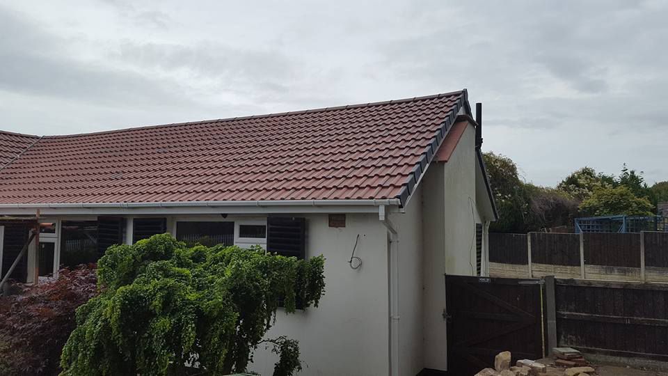 Side view of completed roofing work by our team