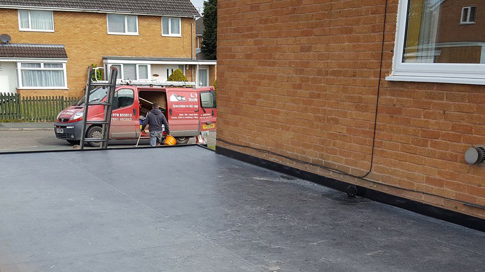 View of a flat roof that has been added to a home