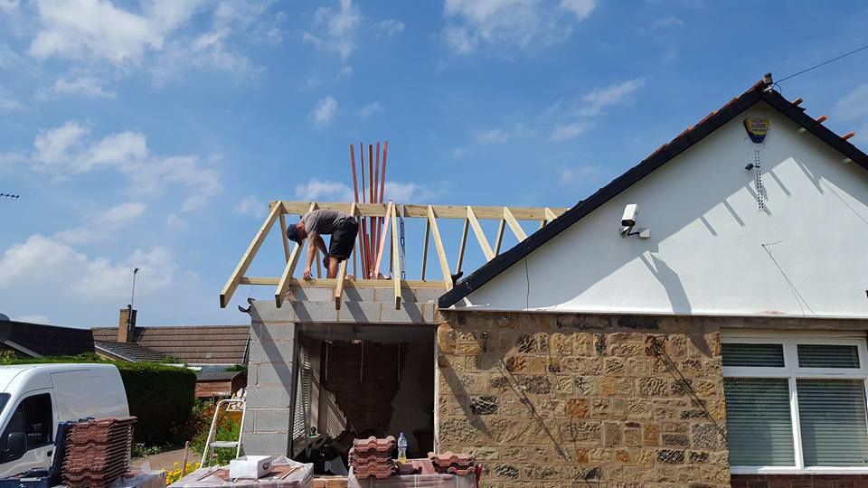 Work being done on a roof being added to an extension 